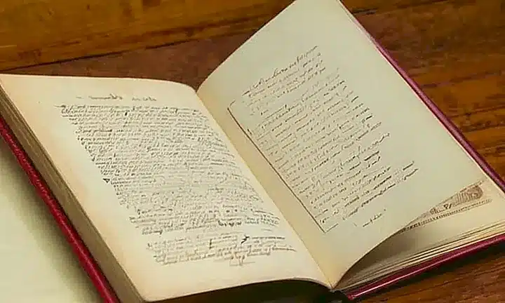 Un documento oficial incluye un título típico y una fotografía de un libro antiguo en una mesa antiguada